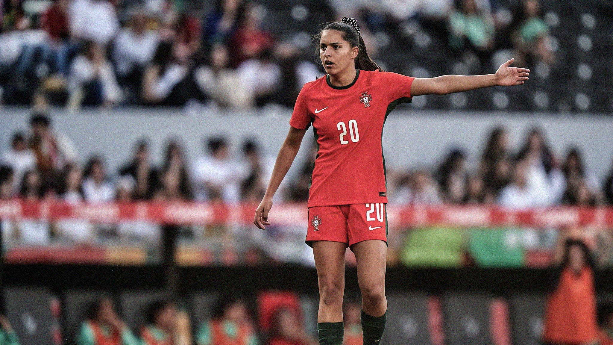 A photo of Kika Nazareth holding her arm out while playing for Portugal
