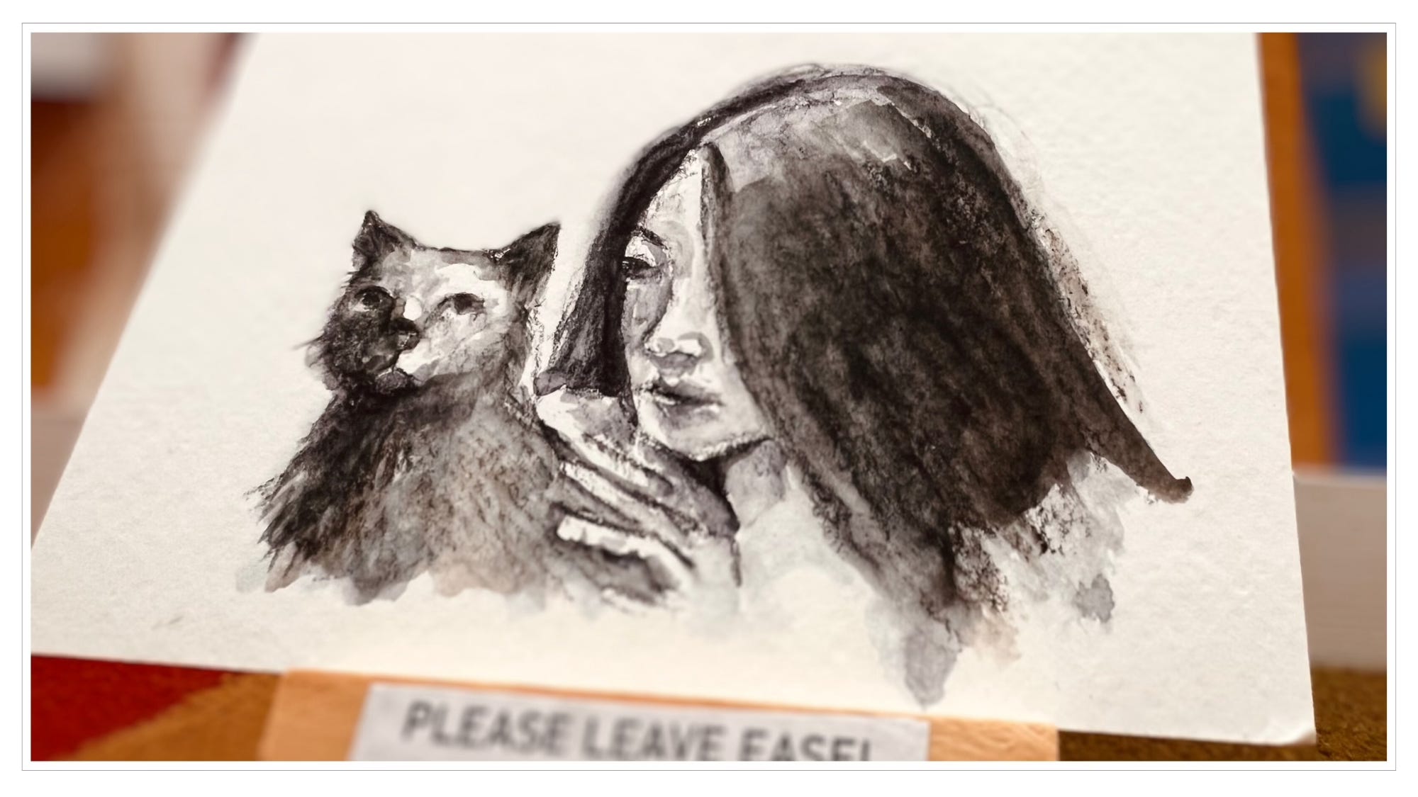 close-up of miniature art: watercolor, woman and cat