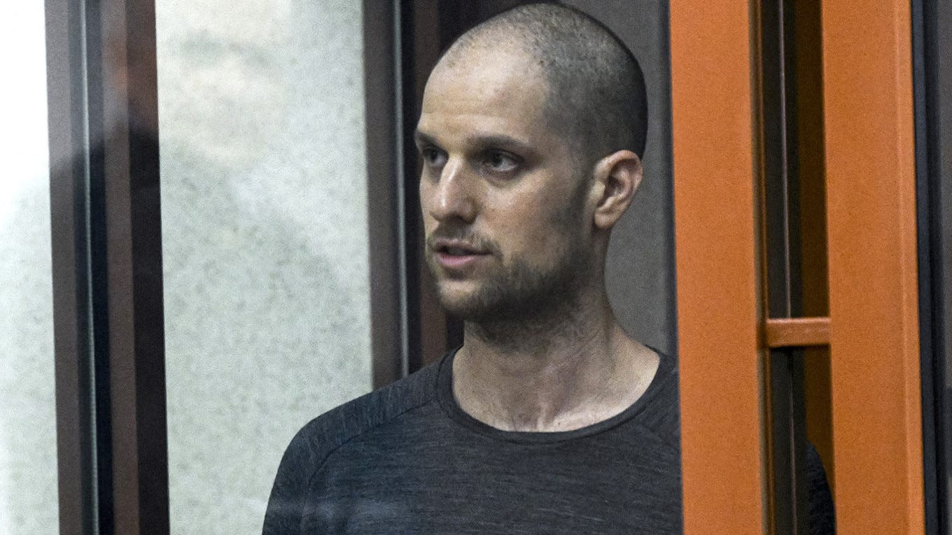 
					Evan Gershkovich stands listening to the verdict in a glass cage of a courtroom inside the building of "Palace of justice," in Yekaterinburg, Russia, on Friday, July 19, 2024. 					 					 Dmitri Lovetsky / AP / TASS				