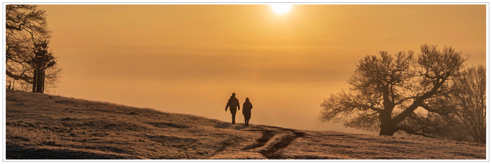 two people walking on path, misty sunrise