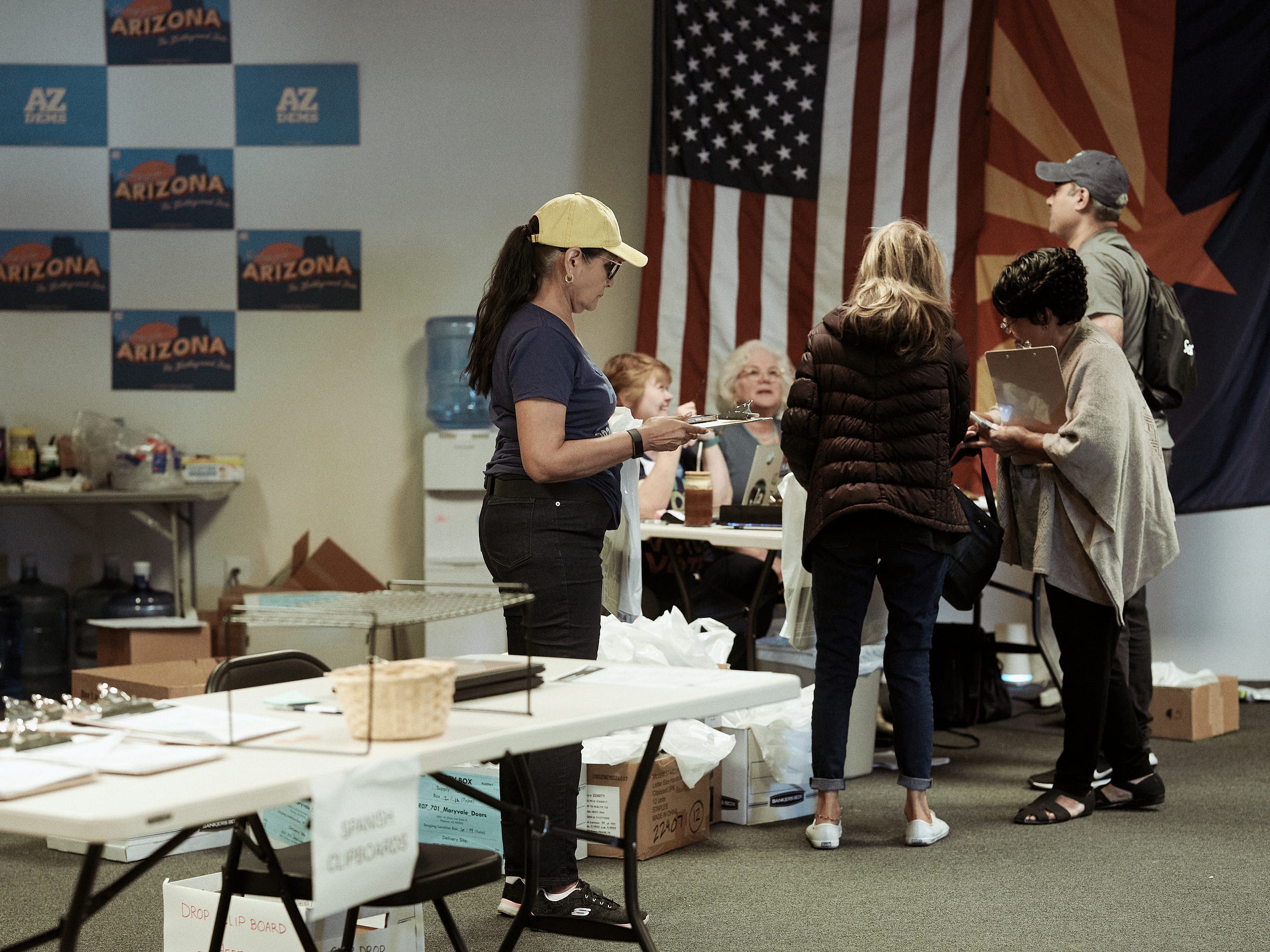 Volunteers picking up another canvassing packet to start their new shift in Phoenix, AZ photographed by Los Angeles documentary photographer Afonso Salcedo