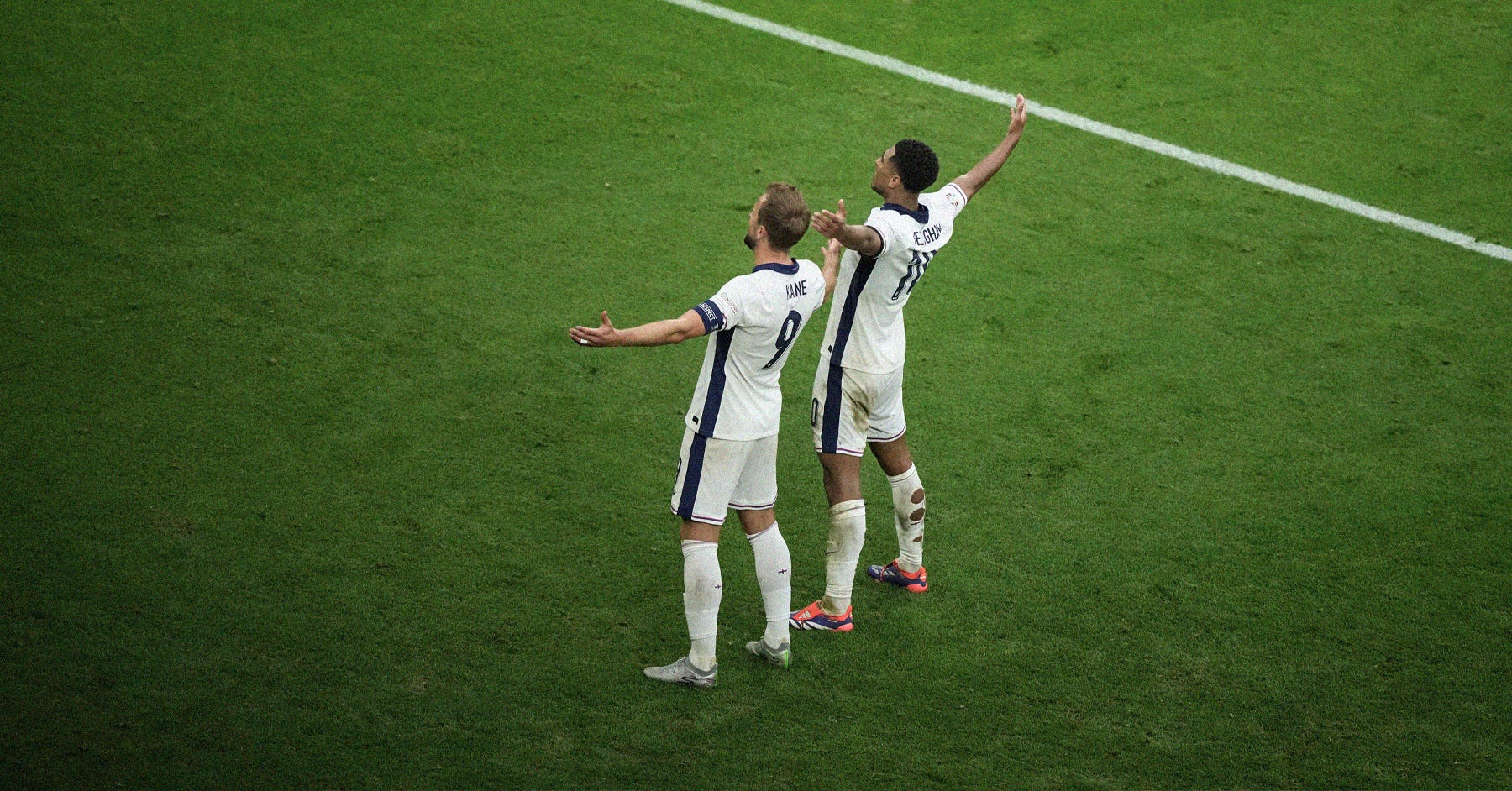 A photo of Harry Kane and Jude Bellingham doing the latter's iconic 'arms out to the crowd' celebration after the 95th-minute equaliser against Slovakia at EURO 2024