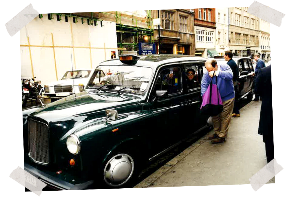 Dad opening his tote bag next to a London taxi, late 1990s.