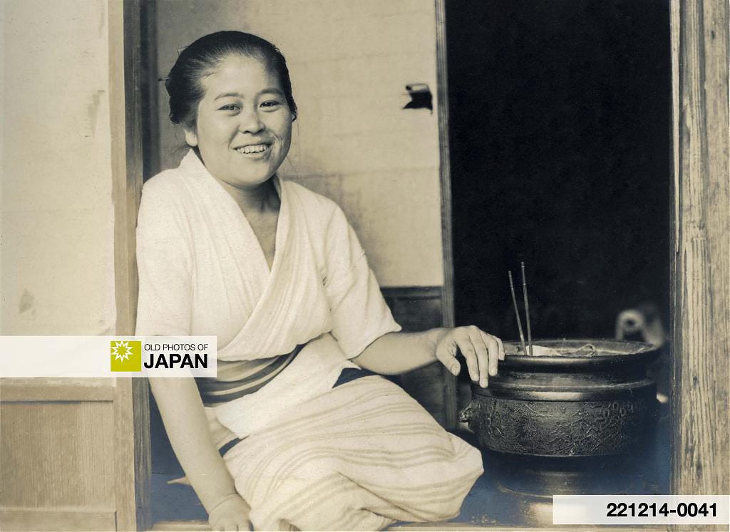 Japanese woman relaxing next to a hibachi, 1910s