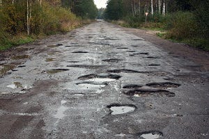 Bad road with lots of potholes