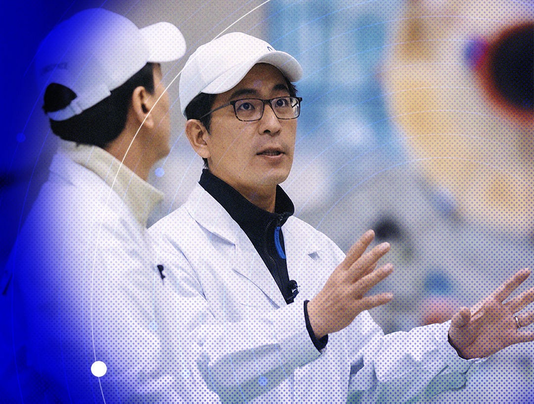 Zhang Changwu (right) explaining part of LandSpace’s manufacturing process to Lu Jian (left).