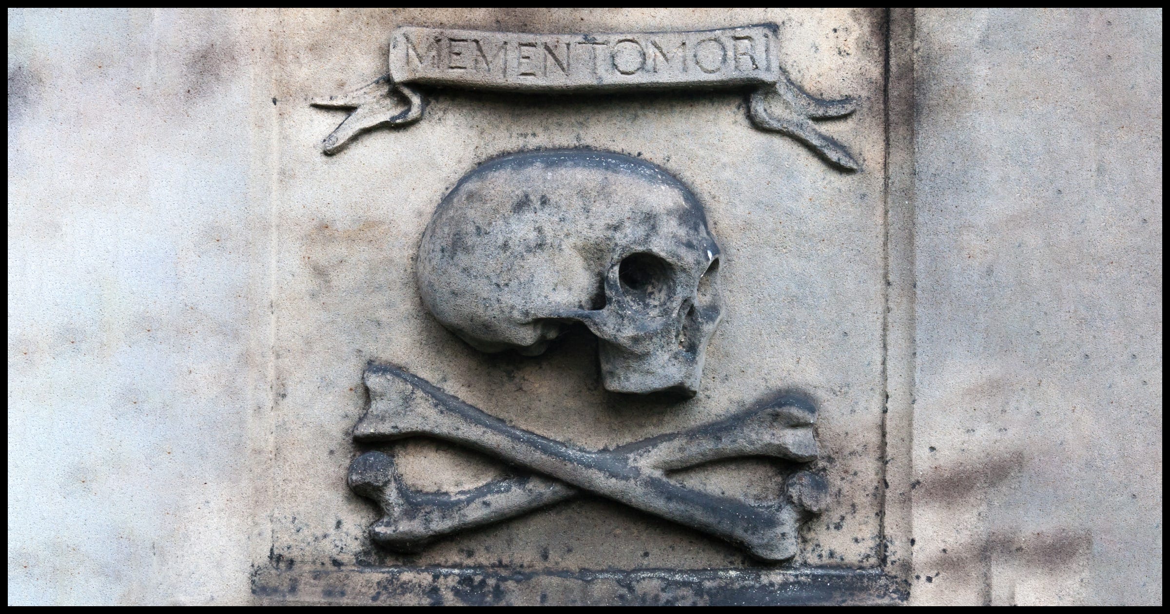 "Memento Mori" over a skull and crossed bones.