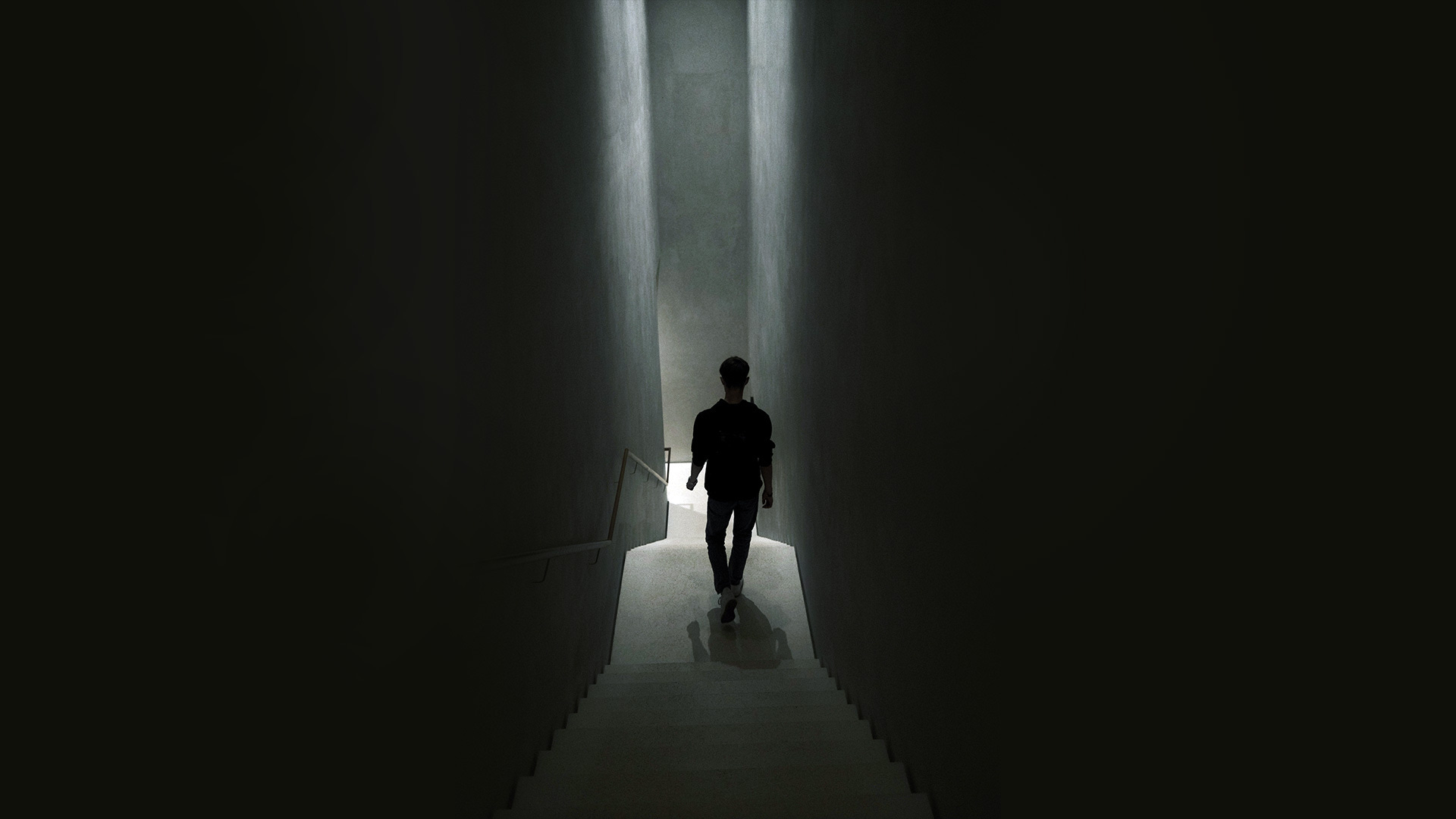 A person walking down a dark staircase