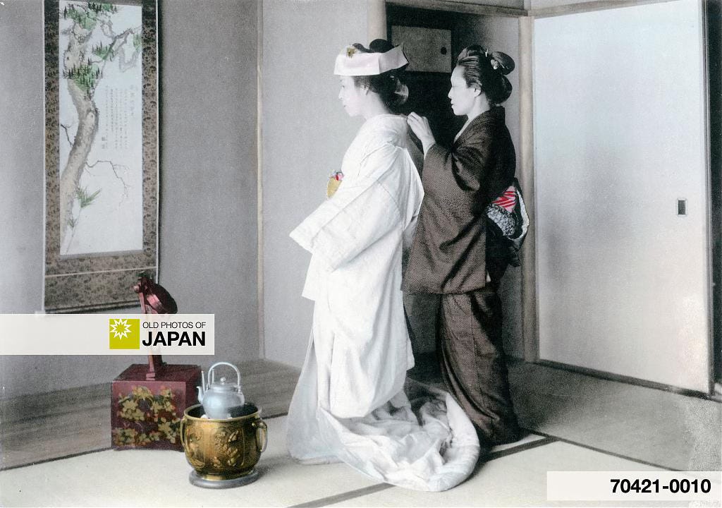 Japanese bride getting dressed next to a metal hibachi with a kettle, 1905 Japanese bride getting dressed next to a metal hibachi with a kettle, 1905