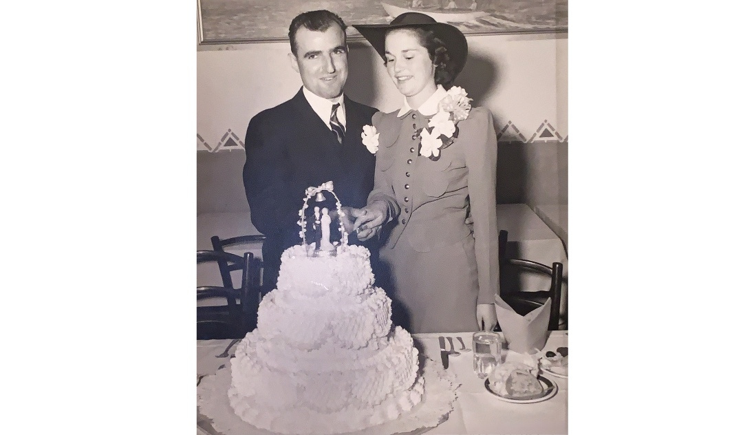 A bride and groom cutting their wedding cake, circa 1940.