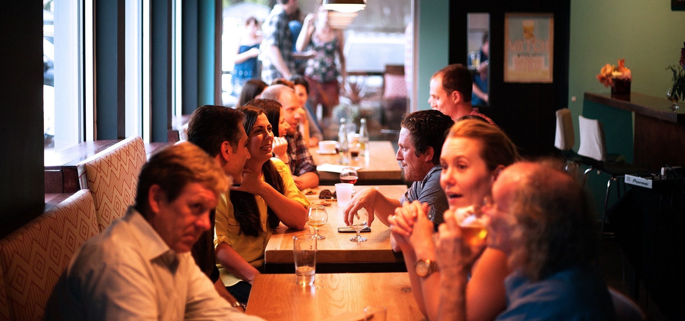 Group of People Sitting at a Restaurant Table