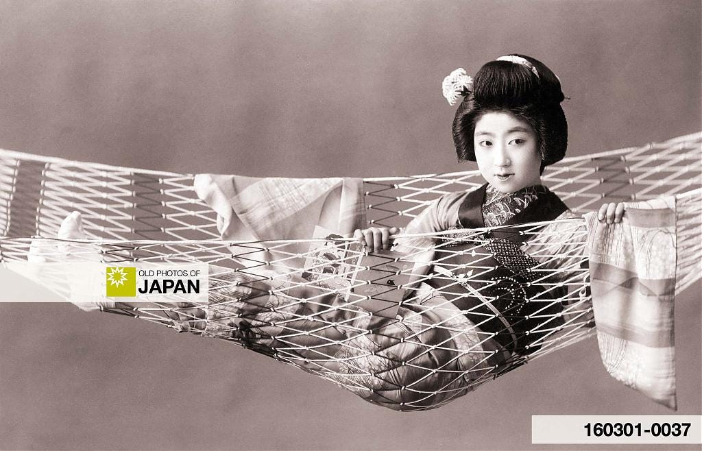 A maiko poses in a hammock, ca. 1920s