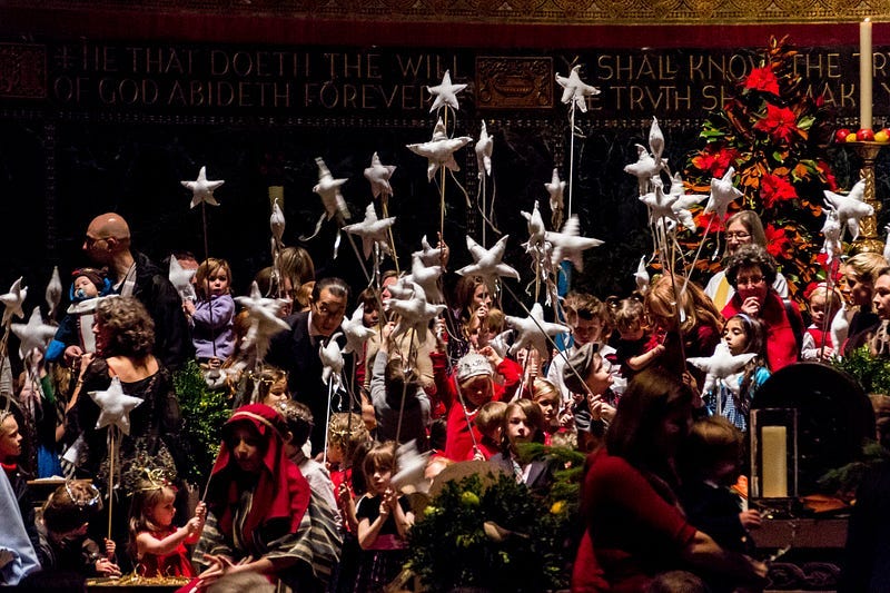 Kid-packed Christmas pageant with lots of kids holding up stars on sticks