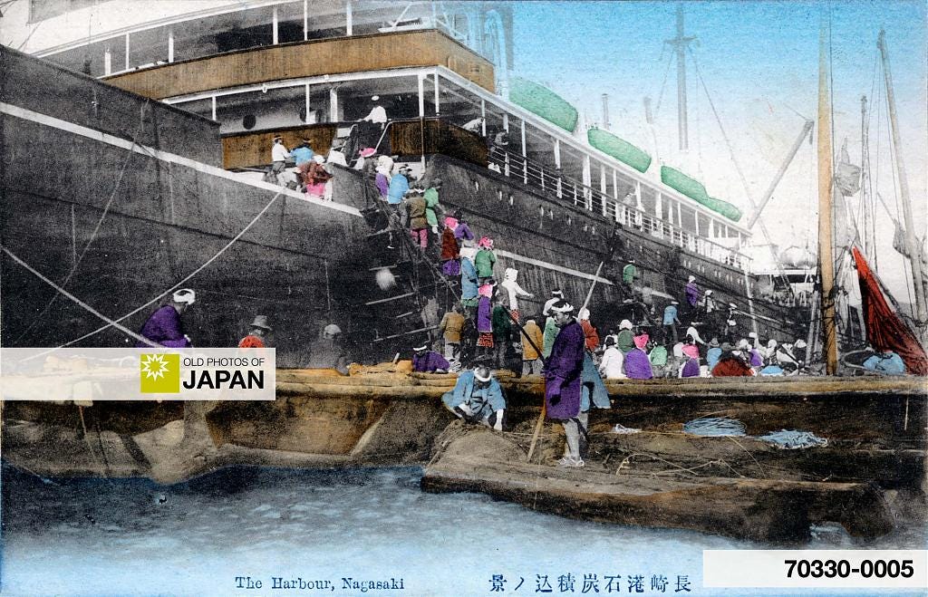 Harbor workers coaling a small steamer in Nagasaki, ca. 1900s