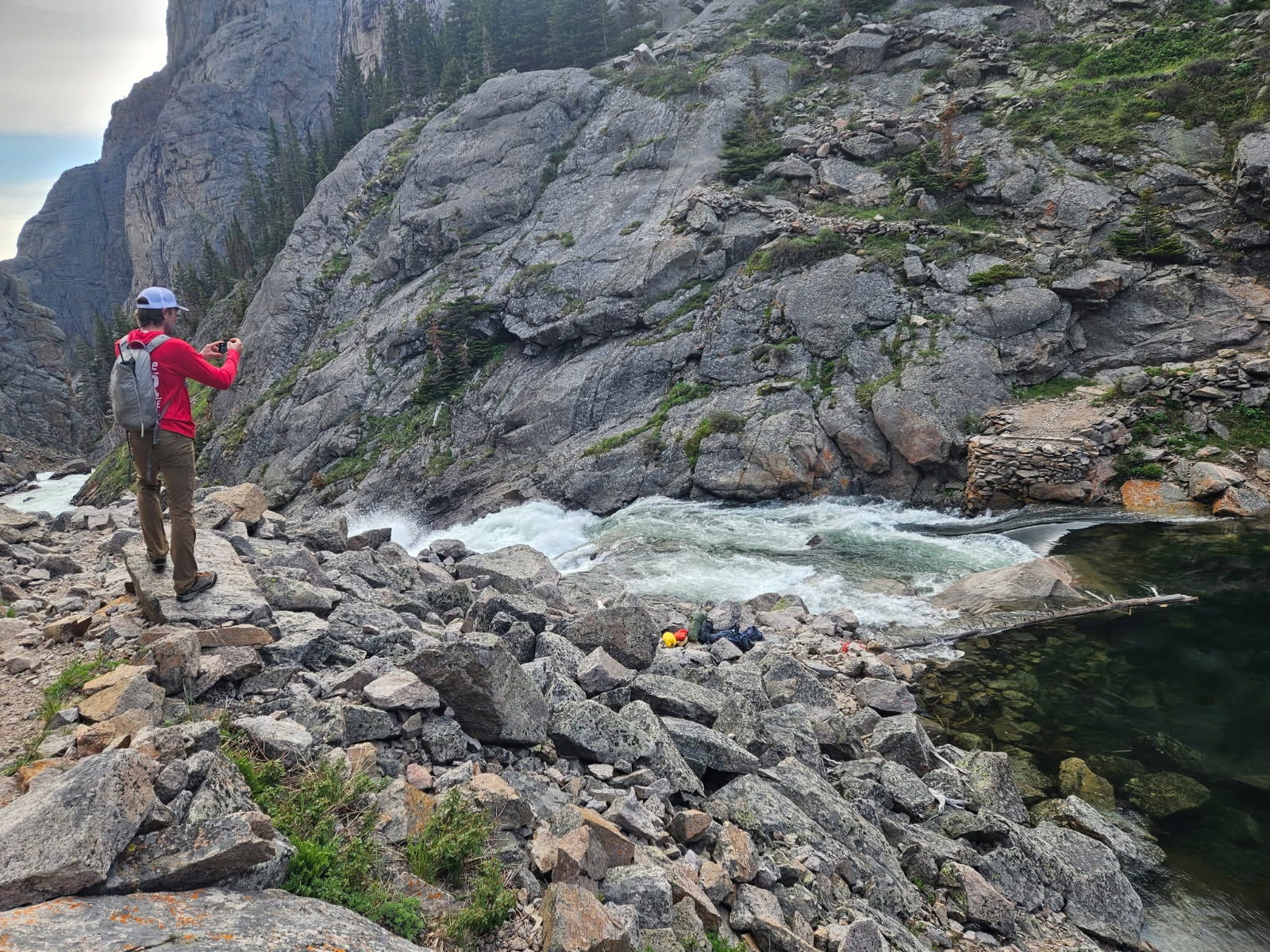 May be an image of 1 person, climbing, body of water and mountain