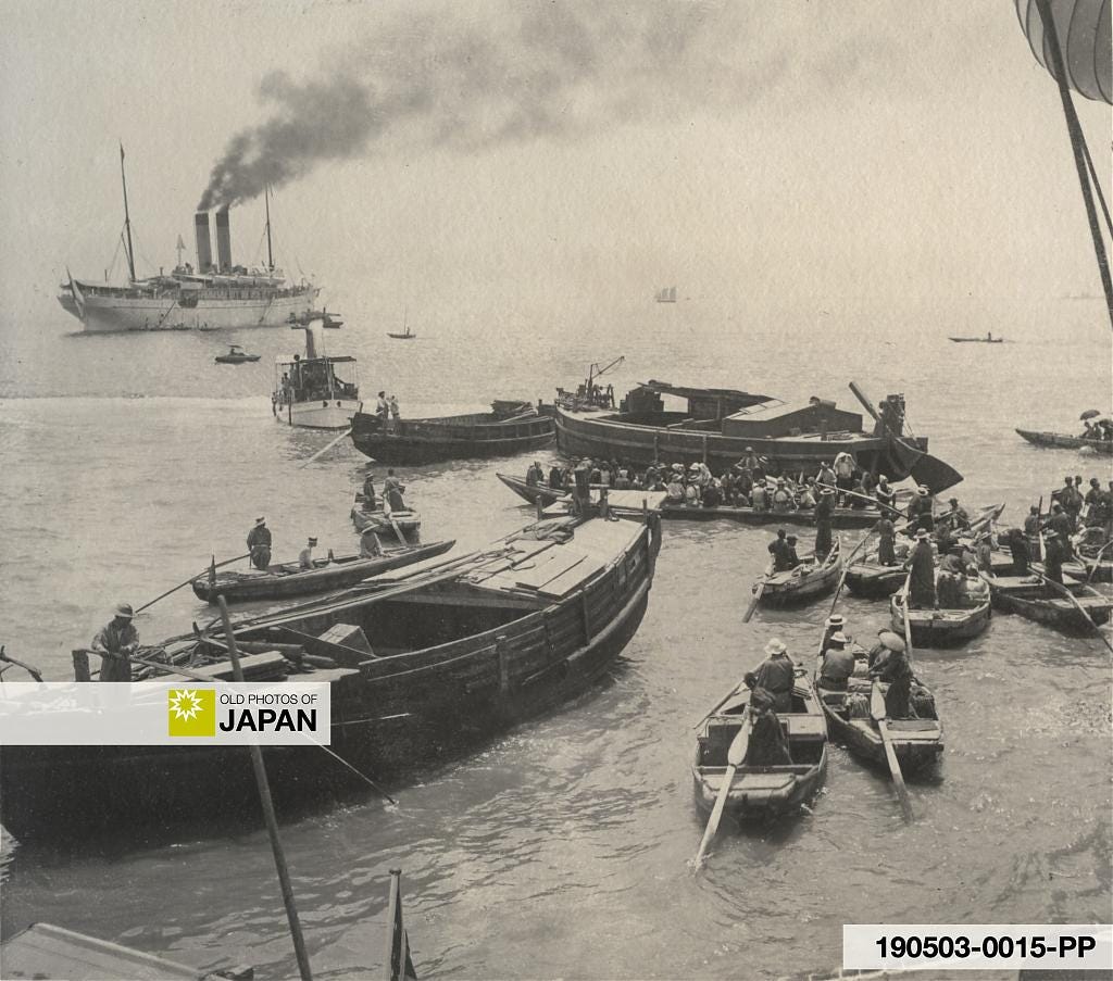 Coal barges, boats with harbor workers, and a steam launch at Kobe Harbor, ca. 1900s