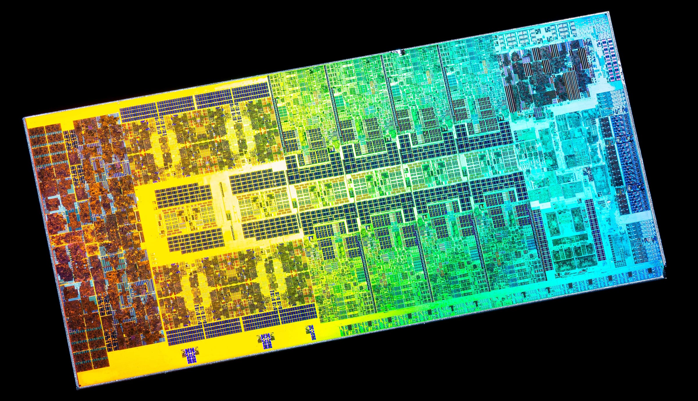 High resolution photo of an Intel CPU where there are many dark rectangles visible which are mostly SRAM blocks used in the design.