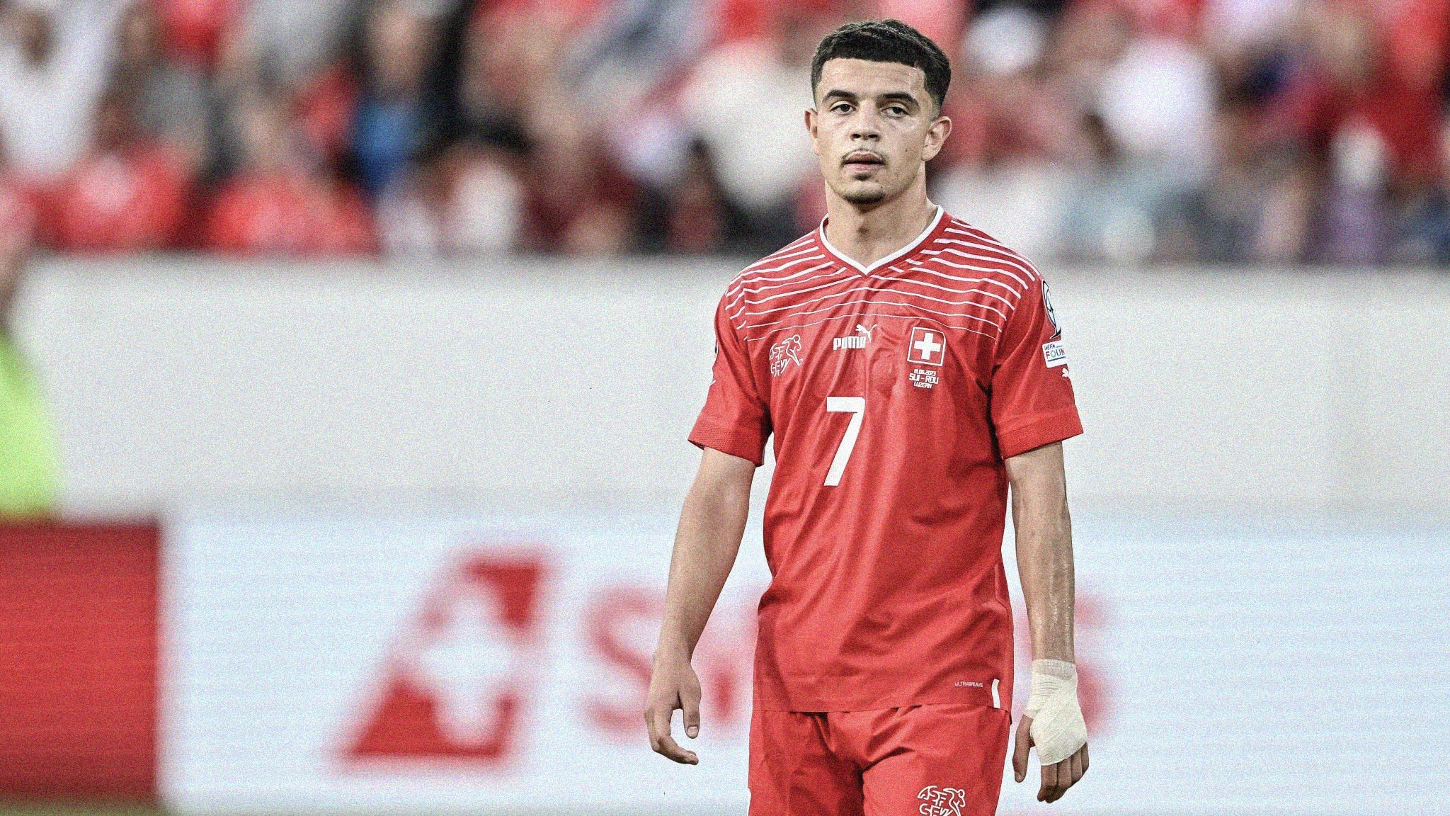 A wide-frame photo of Zeki Amdouni playing for Switzerland, wearing the number seven shirt