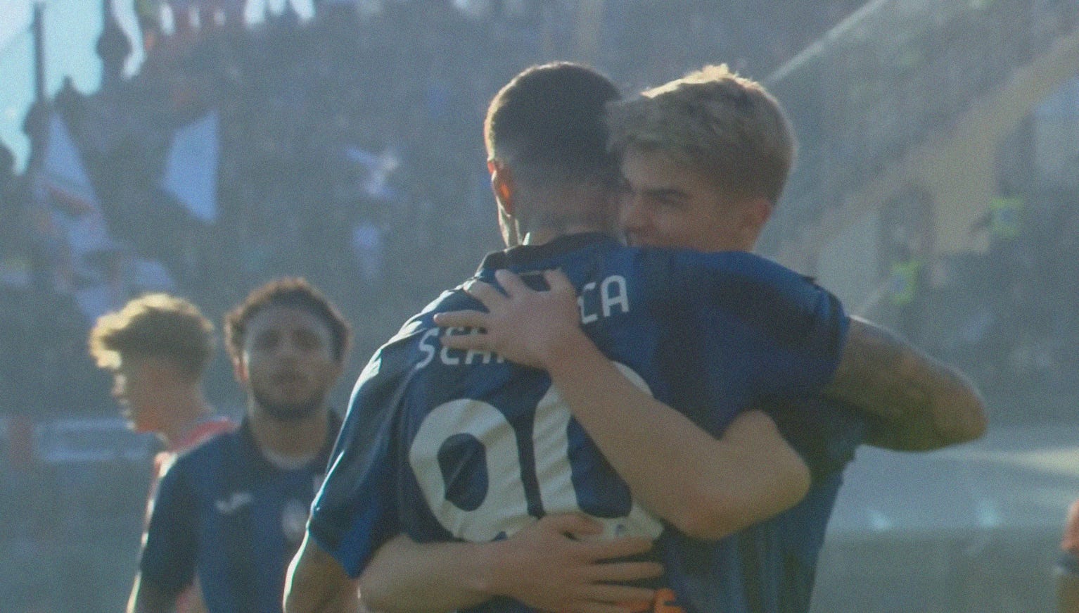 A screenshot of Charles De Ketelaere hugging Gianluca Scamacca.