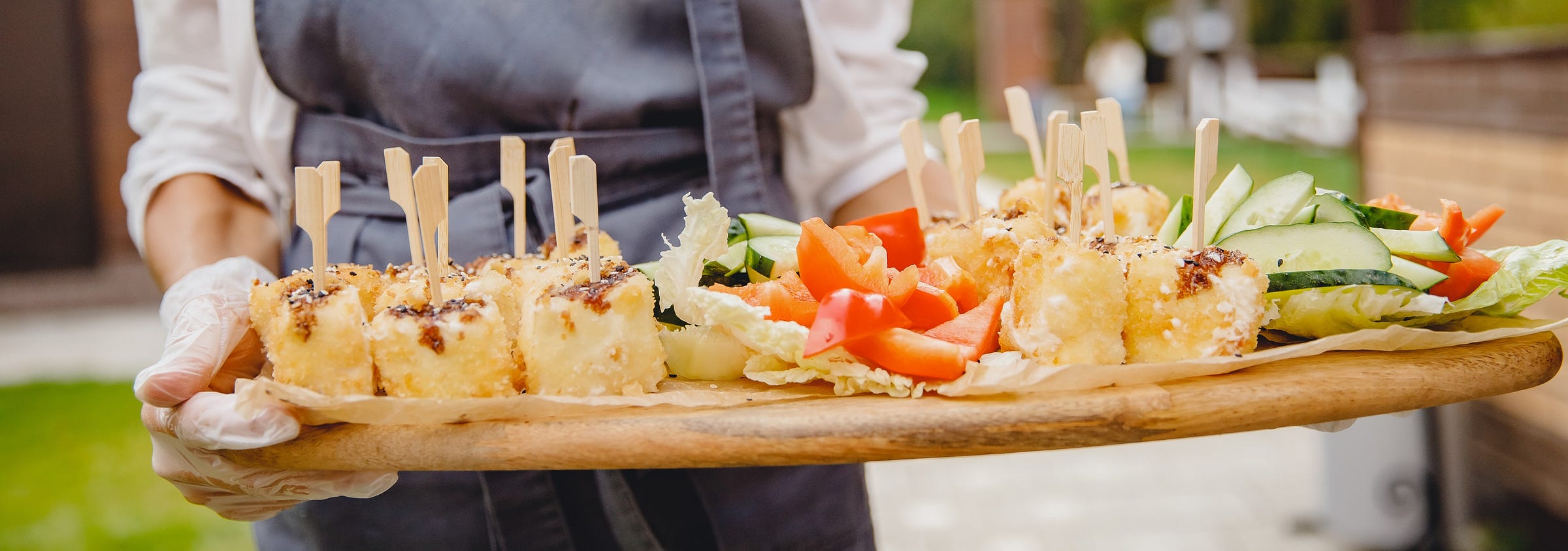 catered hors d'oeuvres platter being carried by a server