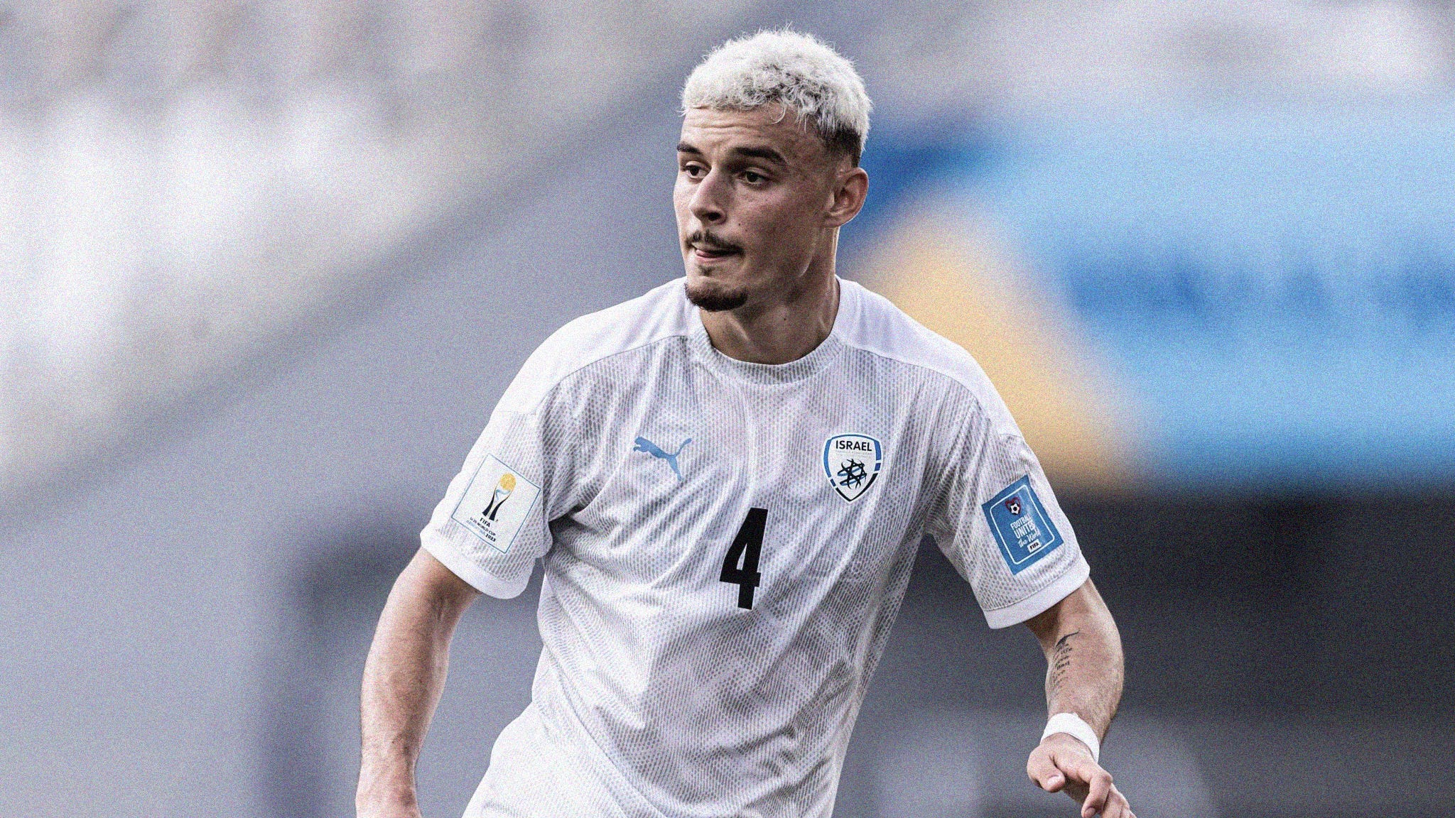 A photo of Israel's Stav Lemking, with bleach-blonde hair, playing at the 2023 FIFA U-20 World Cup