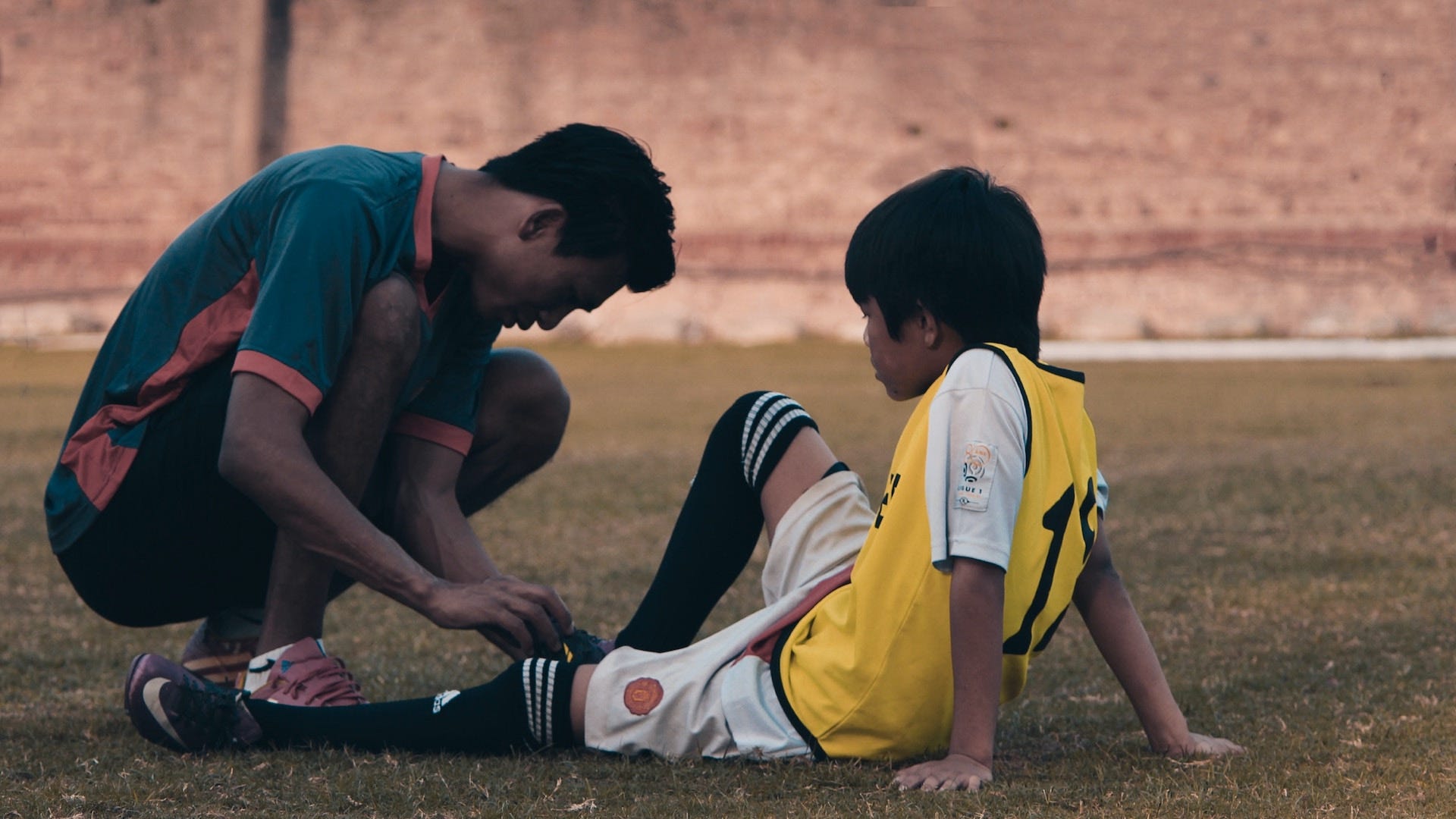 Soccer coach helping a player