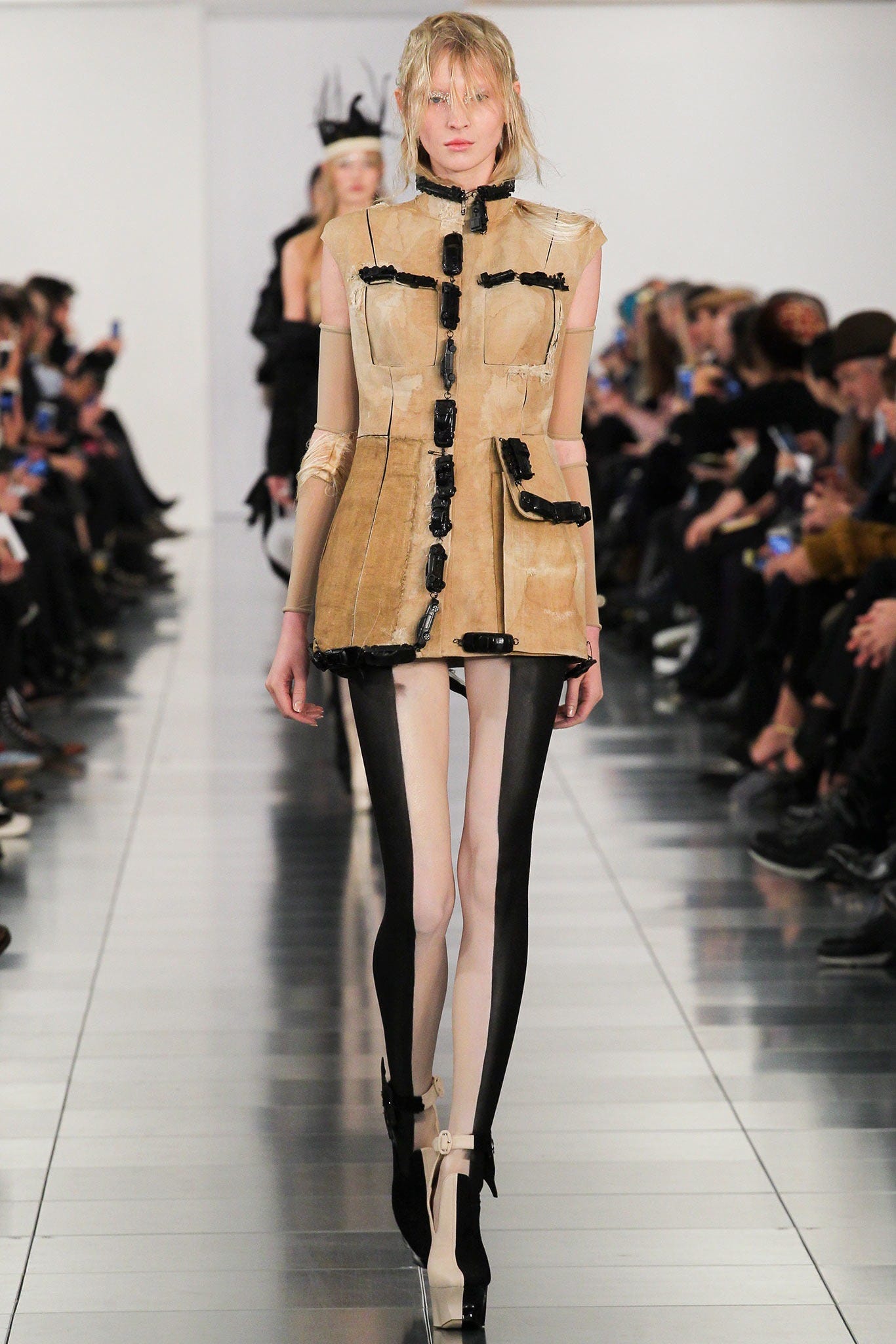 Image may contain Runway Human Person Fashion Shoe Clothing High Heel Footwear Apparel and Coat