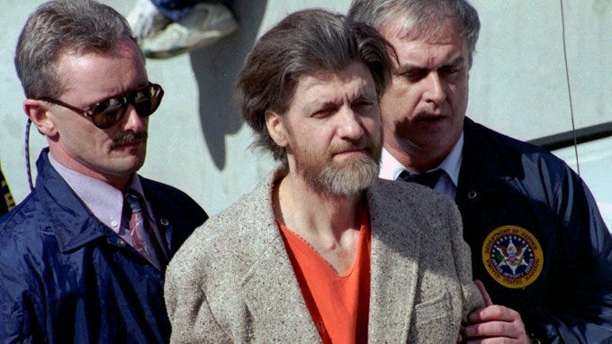 Ted Kaczynski better known as the Unabomber flanked by federal agents as he was led from the federal courthouse in Helena Mont in 1996