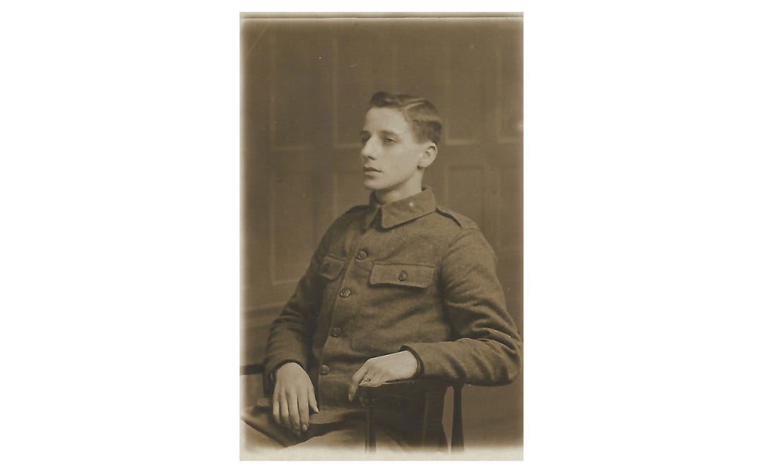 A young man in military uniform is seated in a chair. He's looking away from the camera as if in thought. Photo in the collection of the author.