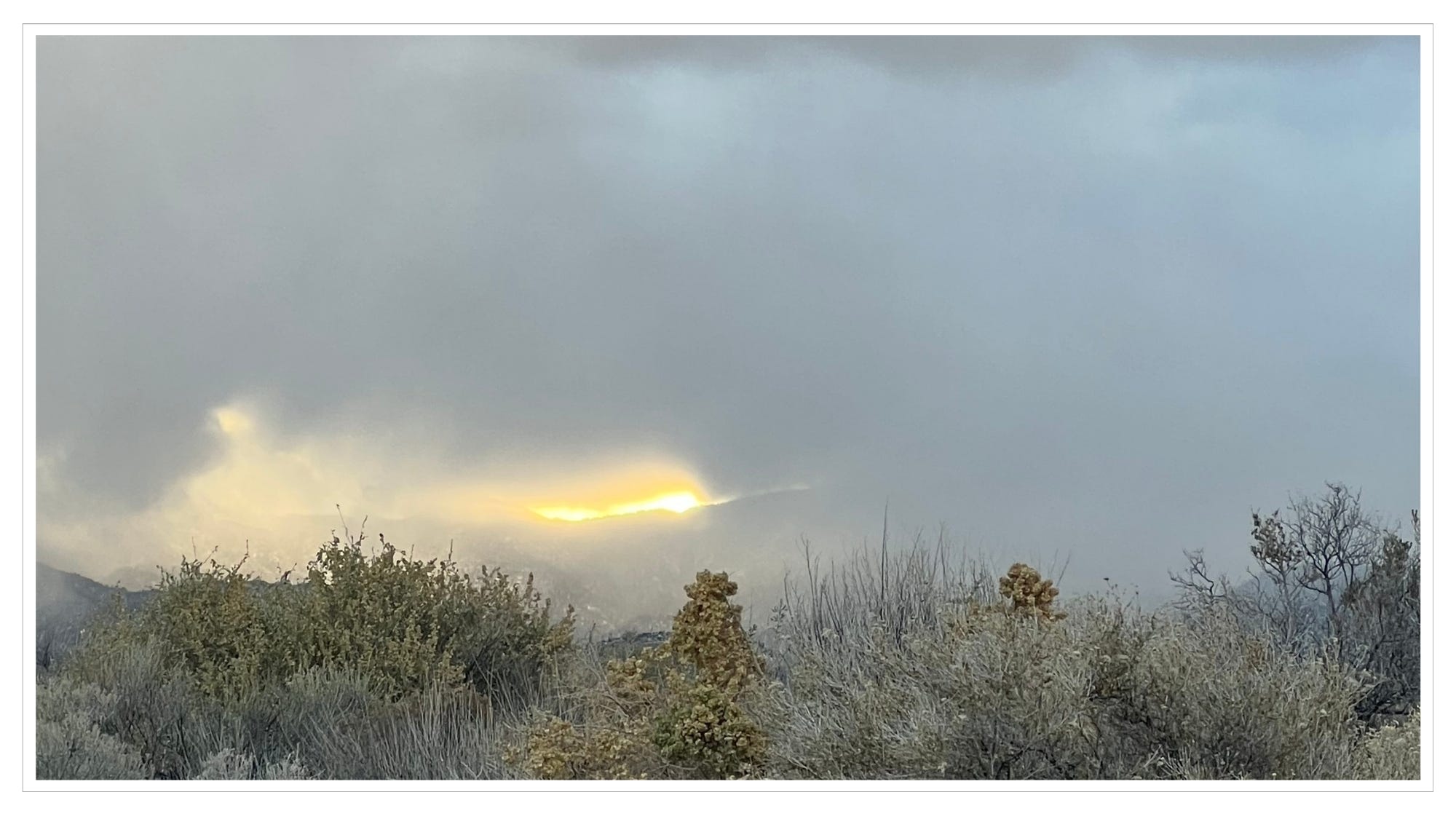 frosty desert, light breaking through morning clouds