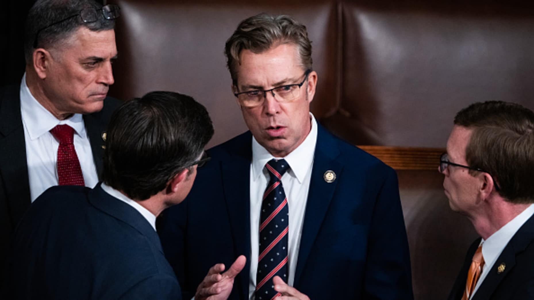 UNITED STATES - JANUARY 3: From left, Rep. Andrew Clyde, R-Ga., Speaker of the House Mike Johnson, R-La., Reps. Andy Ogles, R-Tenn., and Dusty Johnson, R-S.D., talk in the House chamber of the U.S. Capitol before Johnson won the speakership for the 119th Congress on Friday, January 3, 2025. (Tom Williams/CQ-Roll Call, Inc via Getty Images)