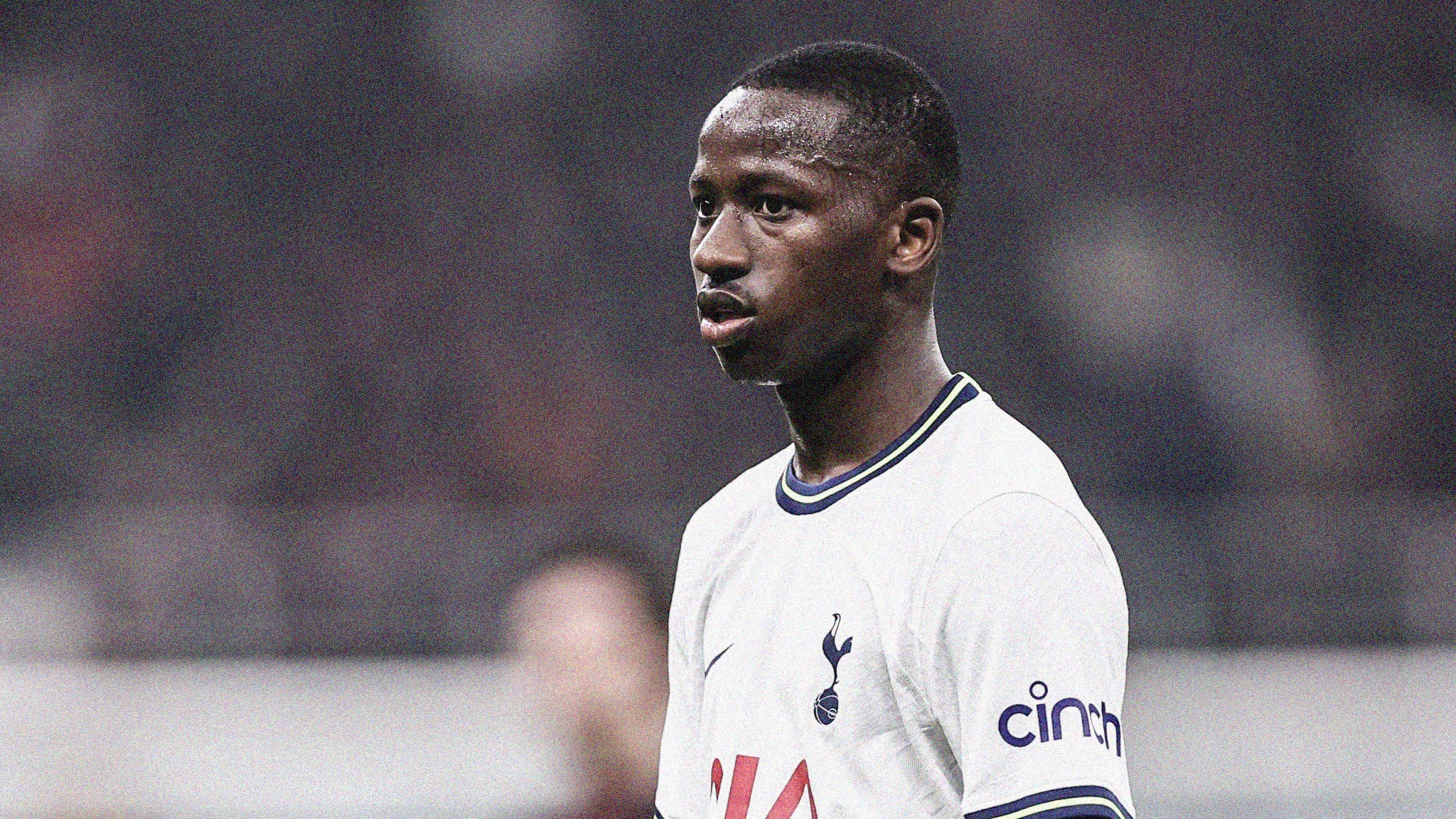 A close-up photo of Pape Matar Sarr playing for Spurs