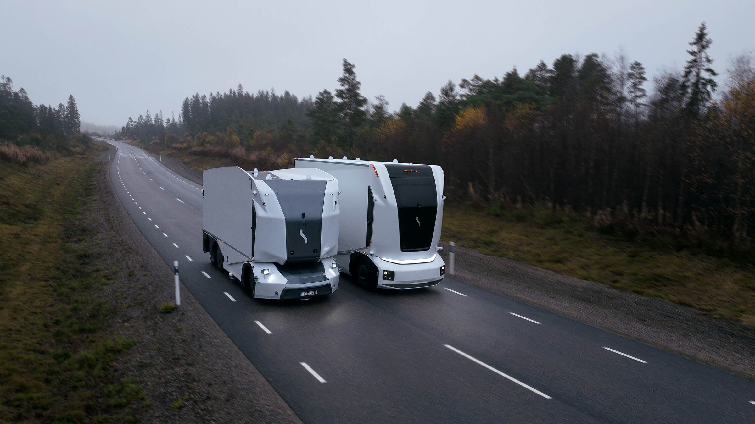 Two autonomous vechles driving besides each other 