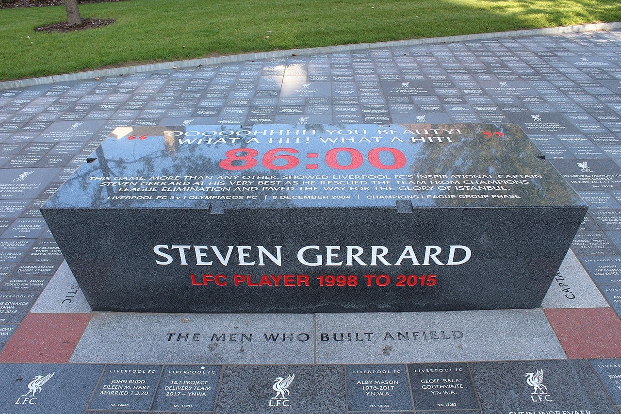 A dark grey plinth with white and red writing on it