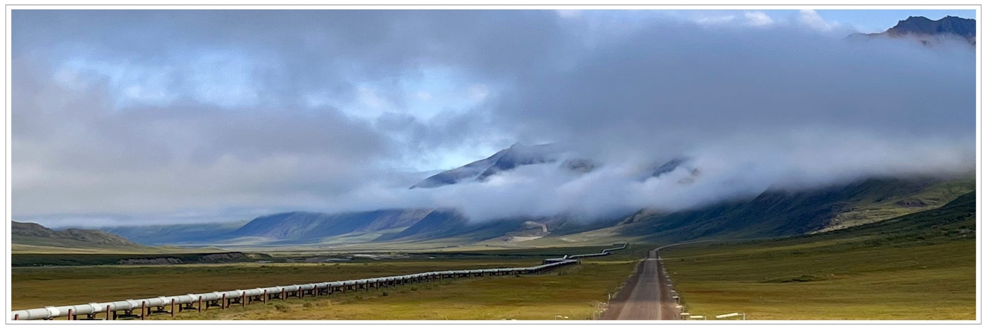 Alaska Pipeline beside Dalton dirt "highway" in Arctic tundra