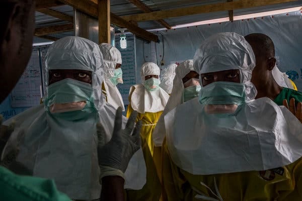 Health workers entering a high-risk ward at an Ebola treatment center in 2014 in Monrovia, Liberia. The outbreak led the Obama administration to study U.S. preparedness for a pandemic.