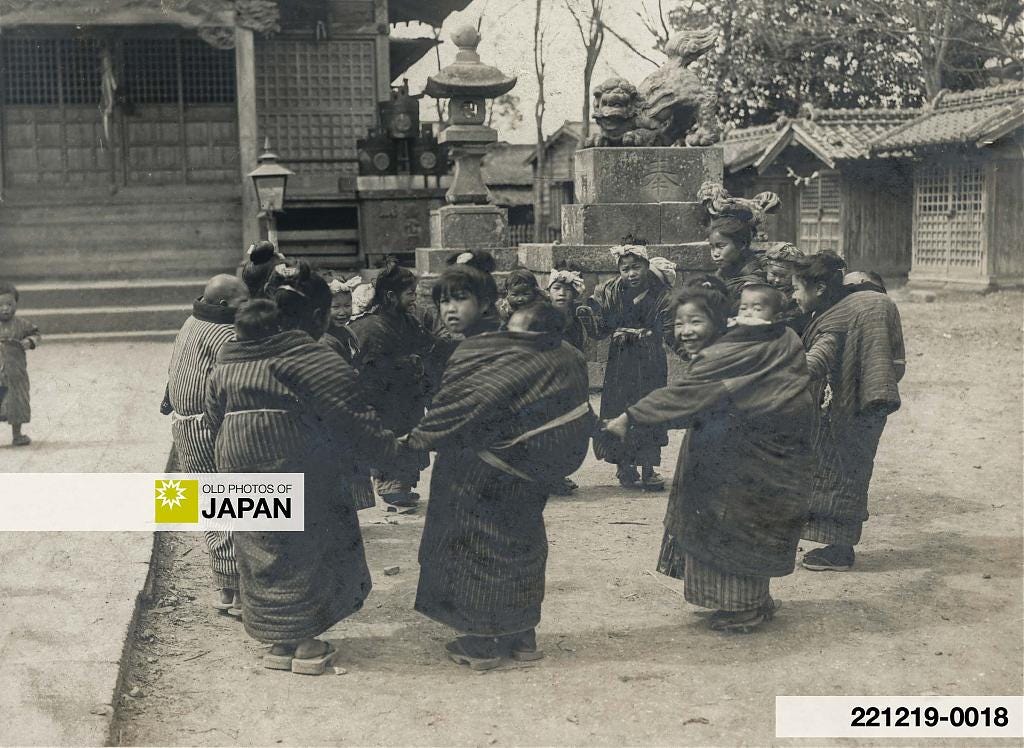 Group of Japanese komori nursemaids wearing oversized padded haori, 1910s