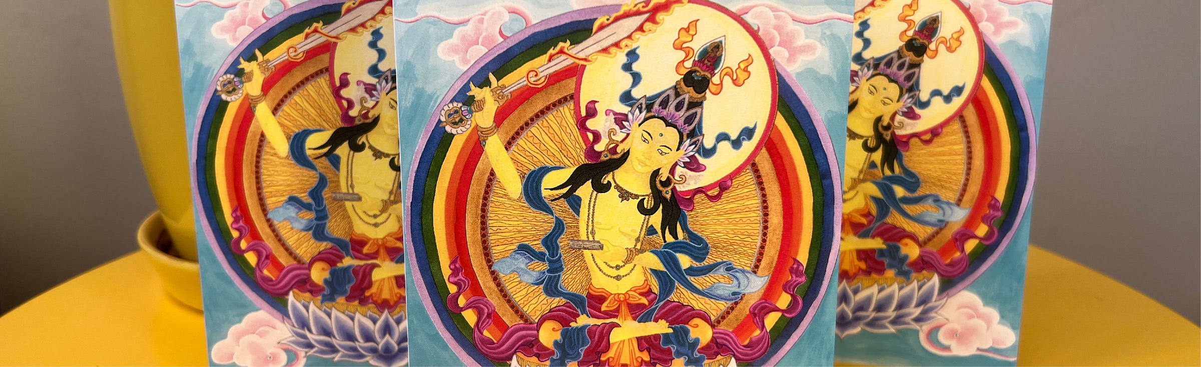 Photo of three greeting cards with a vibrant image of the Bodhisattva Manjushri printed on them. 