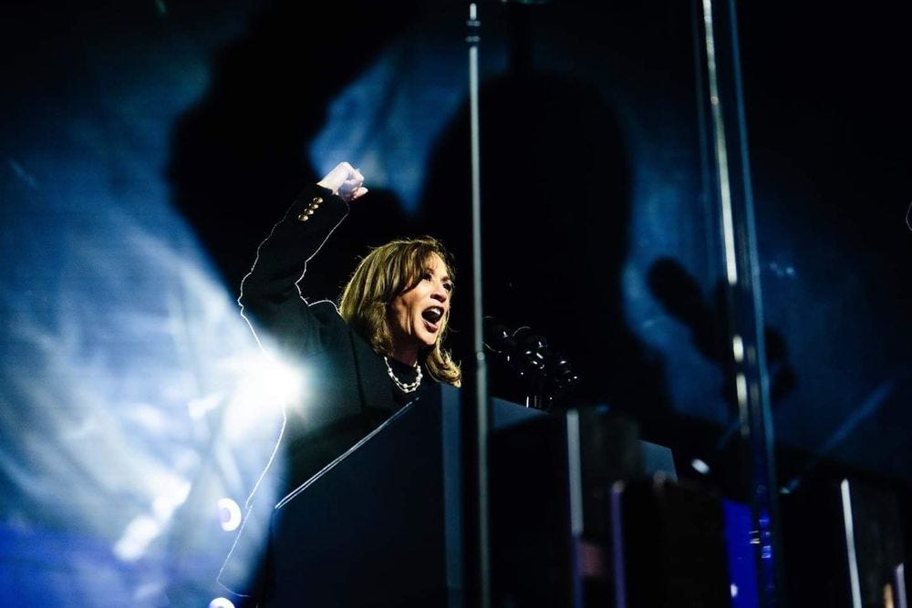 Photo of Kamala Harris with her fist raised, speaking passionately to a crowd.