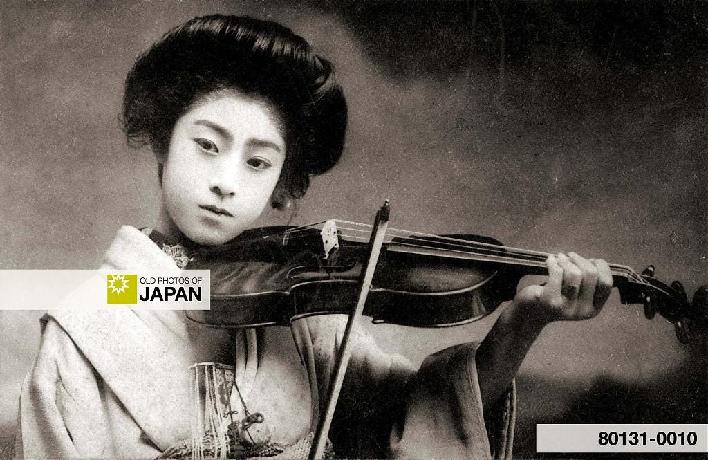 Young Japanese woman with a hisashigami hairstyle poses with a violin, ca. 1910s