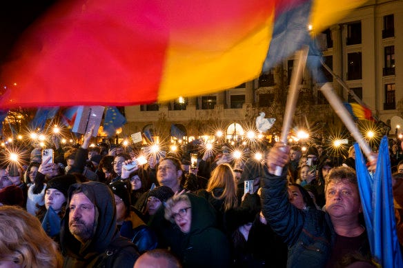 People hold mobile phones with flashlights during a pro-European rally in Bucharest, Romania, on Thursday.