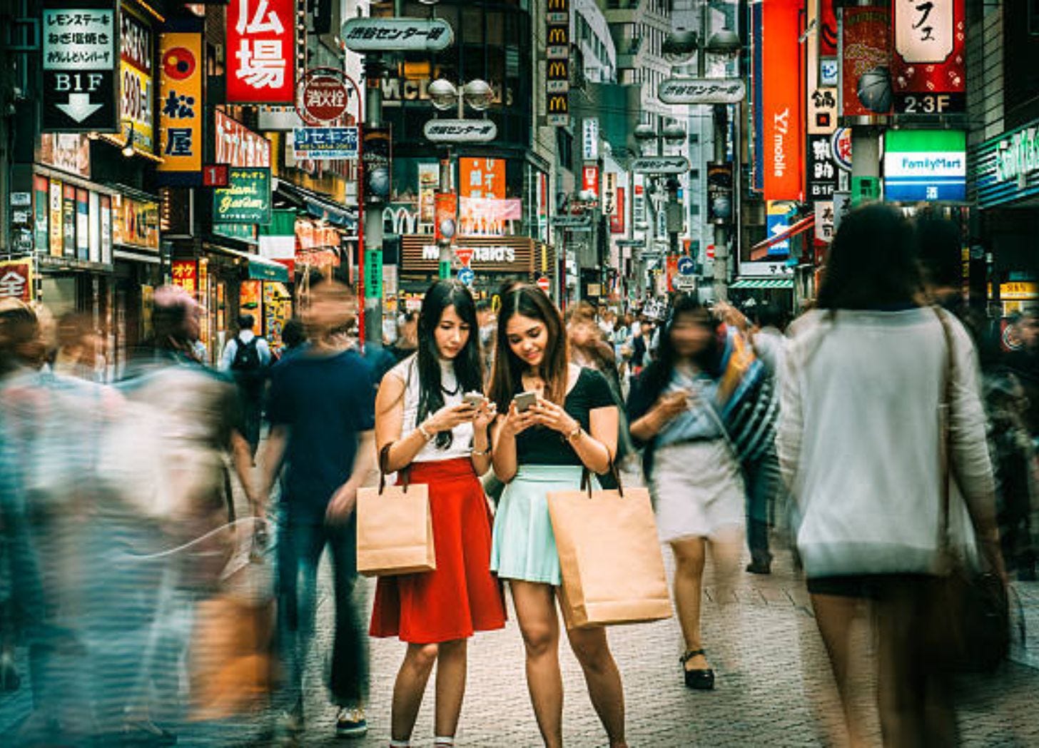 2 girls hanging out on the busy streets of Shibuya in Tokyo, Japan. Image courtesy of ferrantraite via iStock 2 girls hanging out on the busy streets of Shibuya in Tokyo, Japan. Image courtesy of ferrantraite via iStock