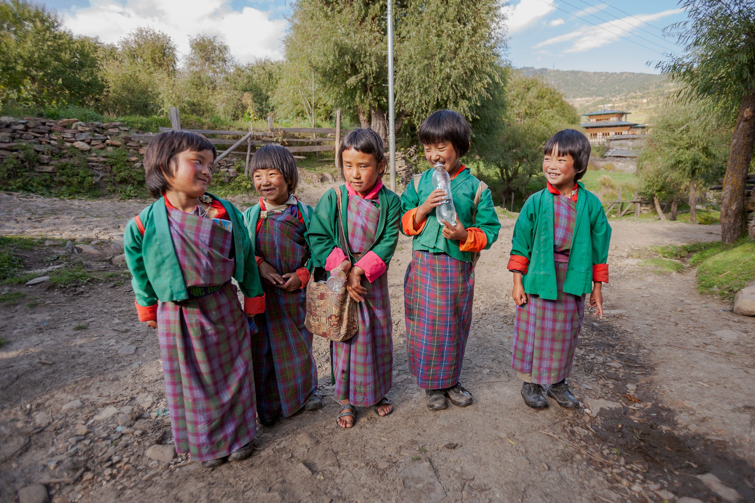 Five giggling schoolgirls on their way home