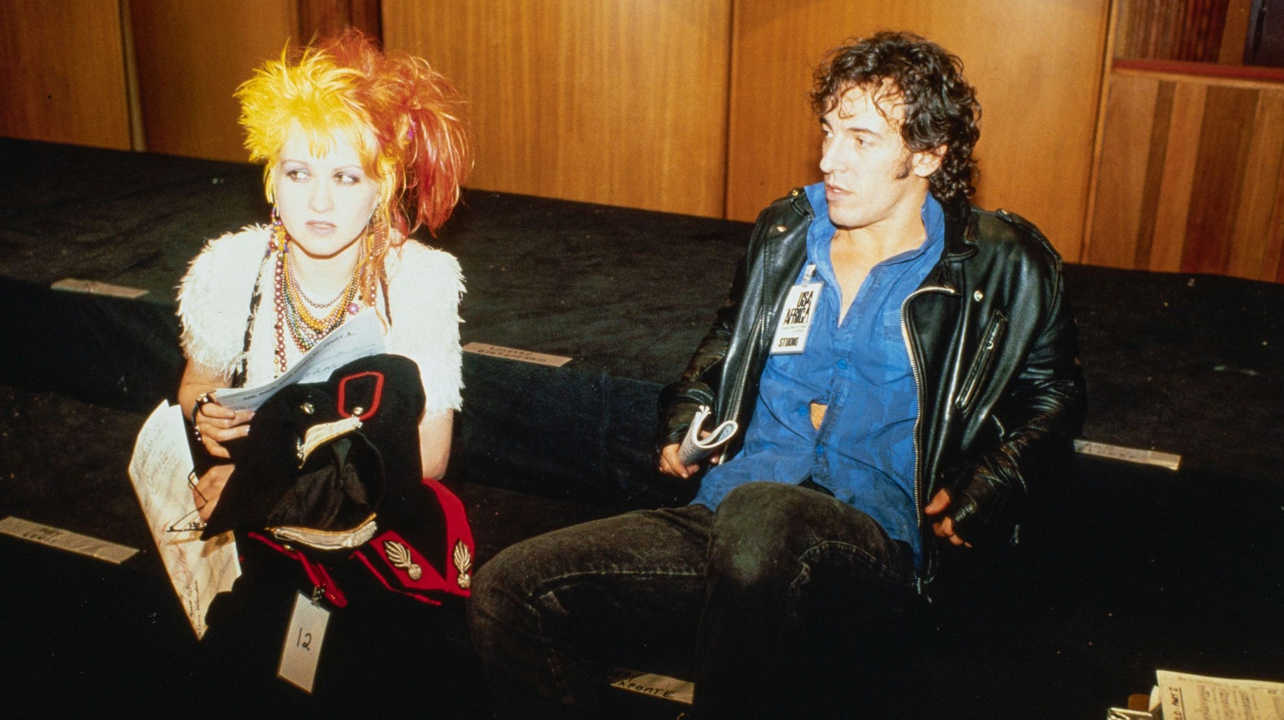 Cyndi Lauper and Bruce Springsteen sitting down looking skeptical