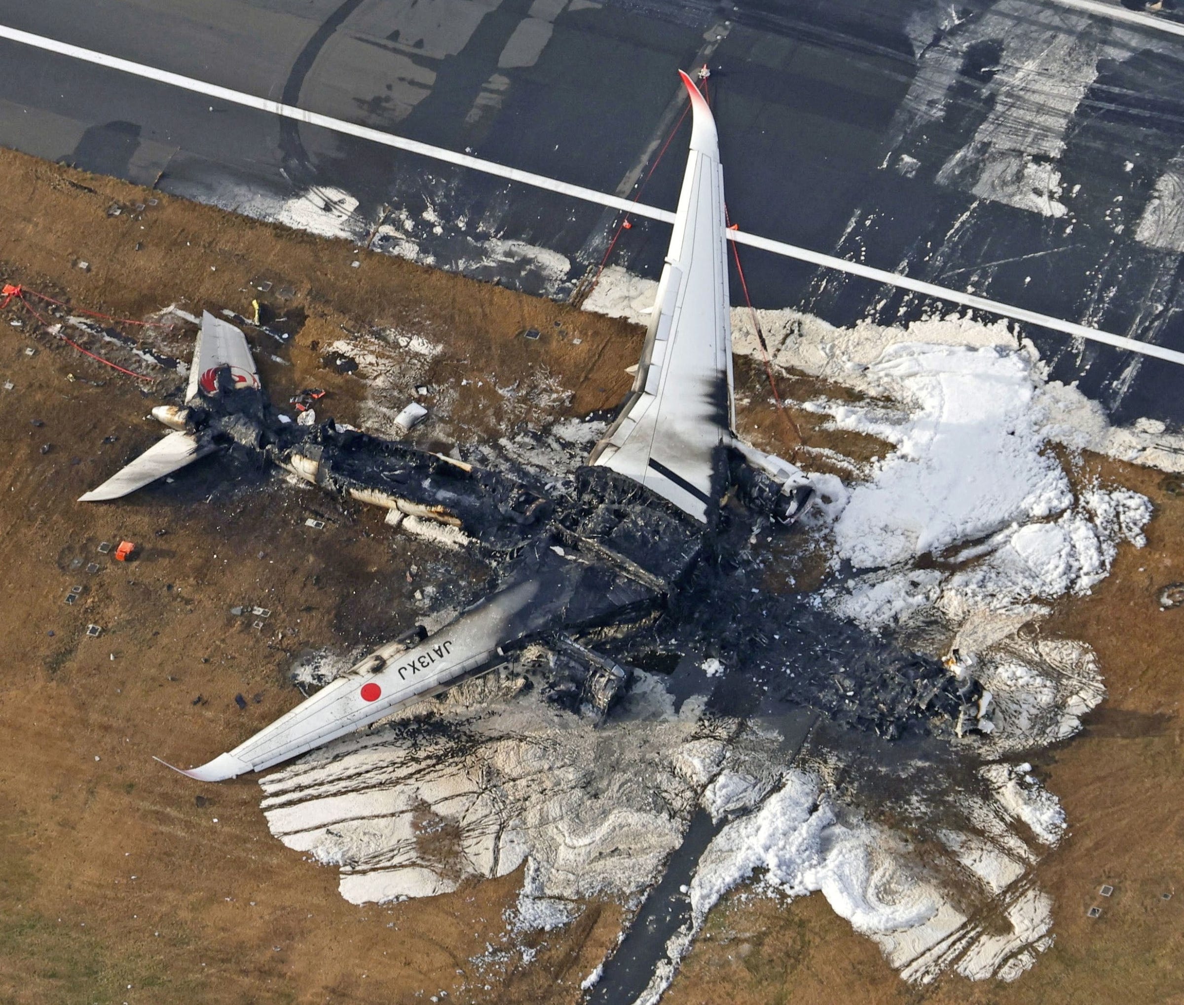 PHOTO: An aerial view shows burnt Japan Airlines' Airbus A350 plane after a collision with a Japan Coast Guard aircraft at Haneda International Airport in Tokyo, Japan January 3, 2024.