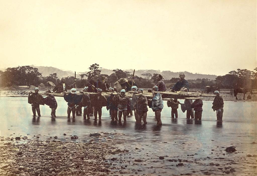 Photo by Felice Beato of porters carrying passengers across the Sakawagawa River, 1866–1867