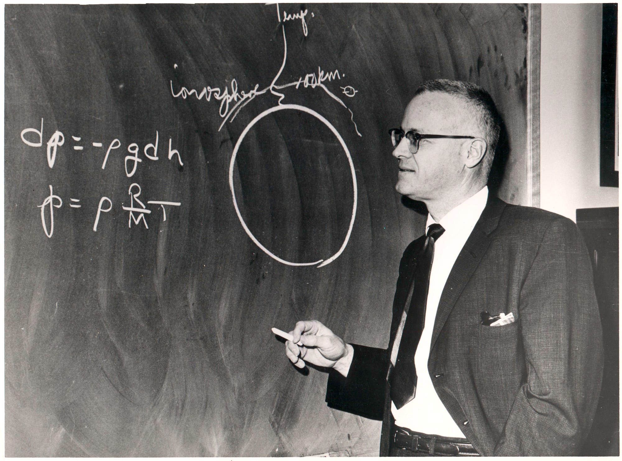 NASA scientist Homer E. Newell Jr. explaining some physics on a chalkboard, c. 1973