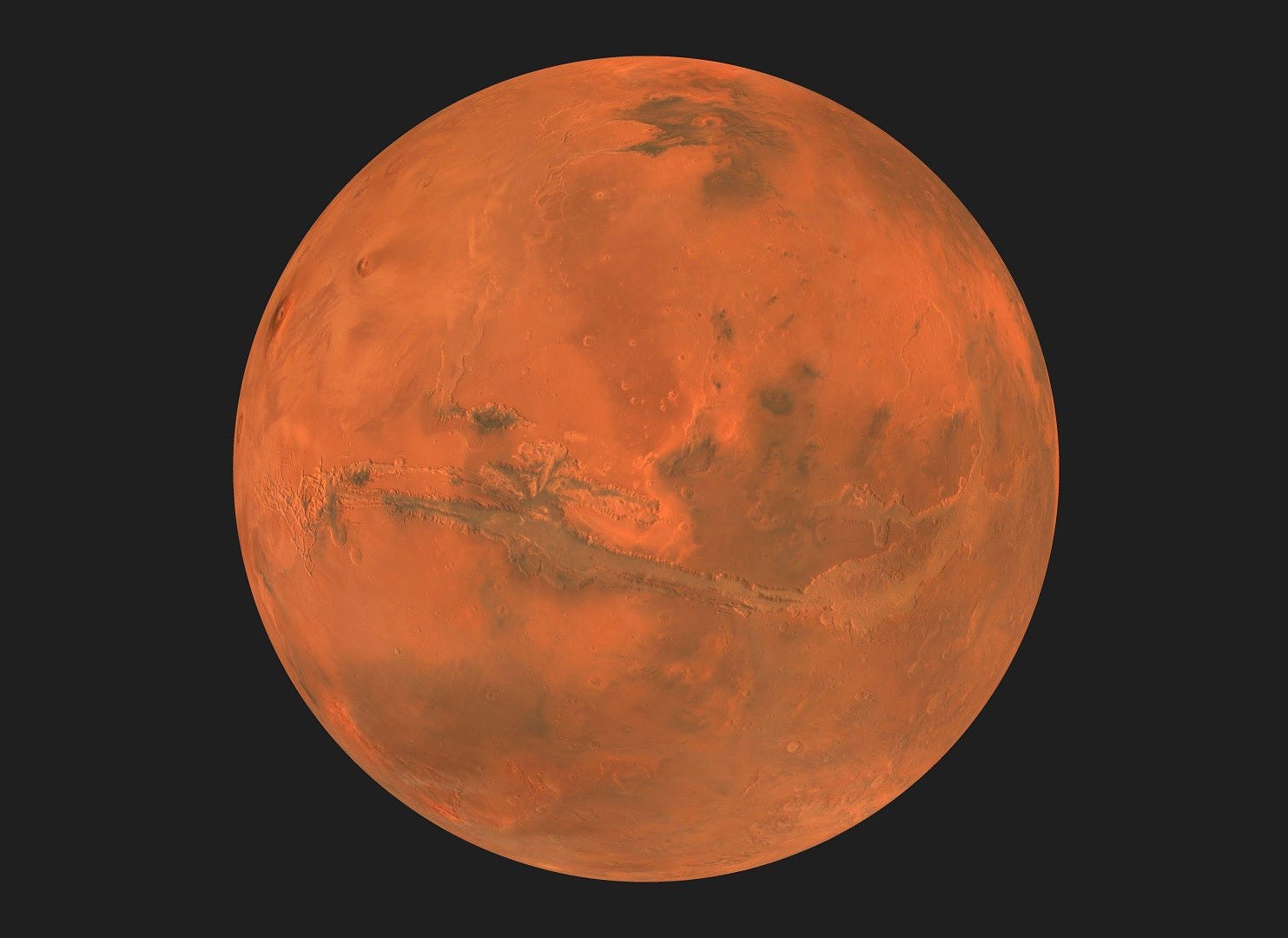 Mars appears as a large orange-red disk with some darker areas of volcanic basalt. Mars appears as a large orange-red disk with some darker areas of volcanic basalt.