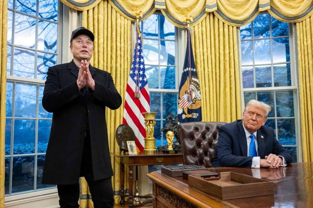 Elon Musk takes questions from reporters as President Trump looks on in the Oval Office of the White House on Tuesday.