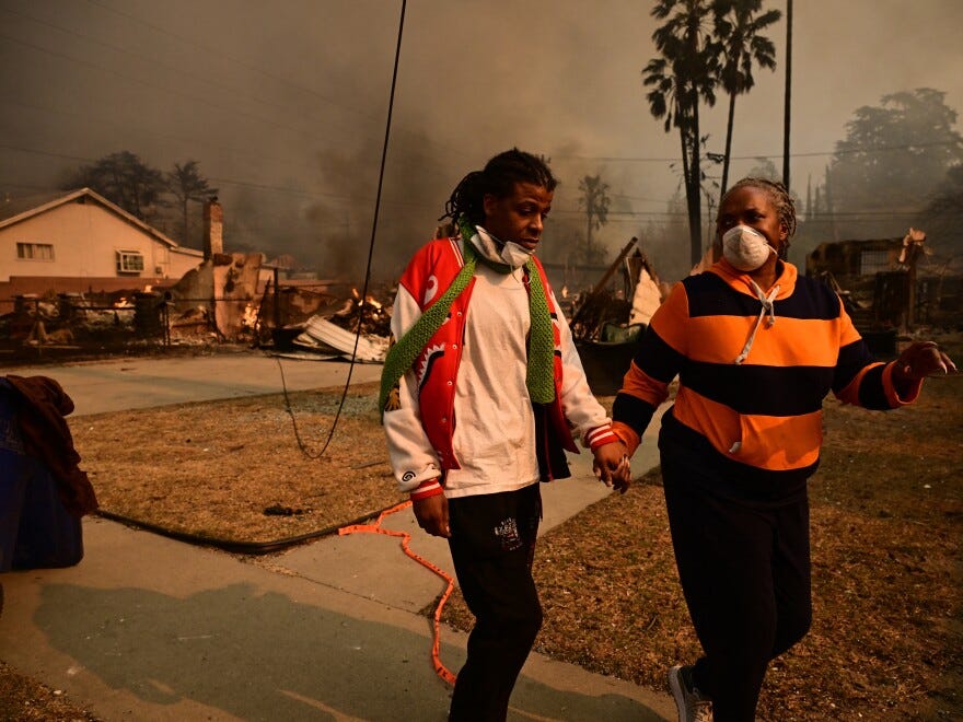 Wed., Jan. 8: Residents walk past homes burnt by the Eaton Fire.